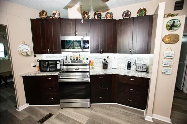 a kitchen with stainless steel appliances granite countertop a refrigerator and a stove