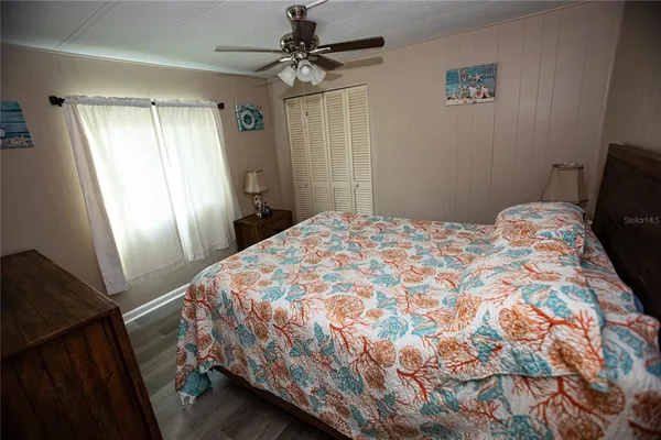 a bedroom with a bed and a window