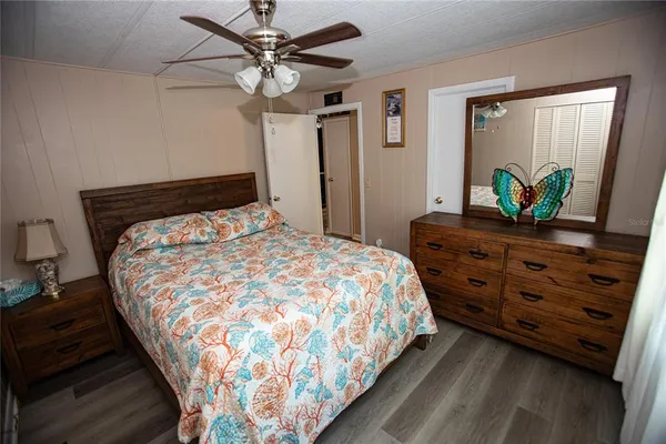 a large bed sitting in a bedroom next to a window