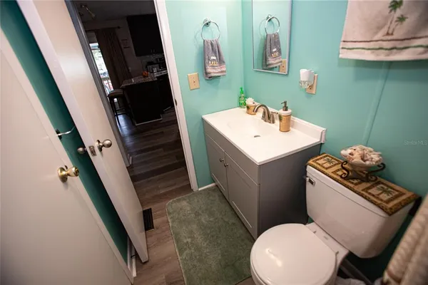 a view of a workspace with furniture and wooden floor