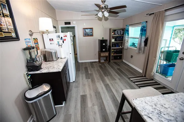 a bedroom with a bed and a dresser with wooden floor