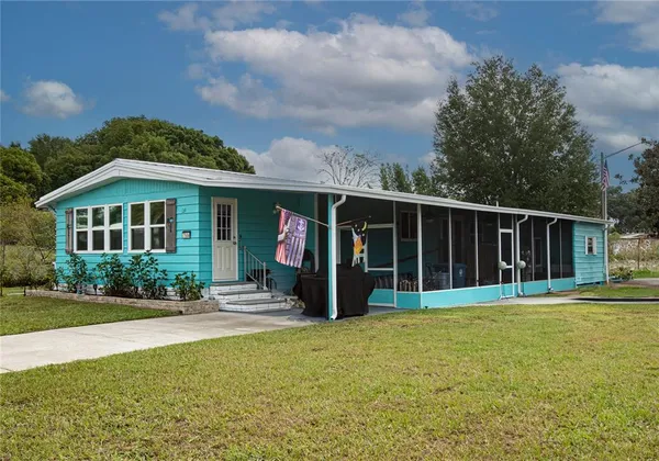 a view of a house with garden and trees