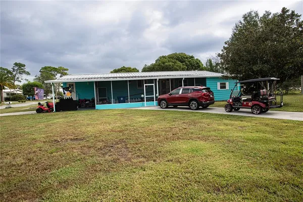 a front view of a house with a garden and trees