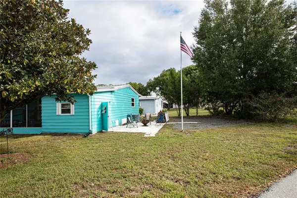 a backyard of a house with table and chairs
