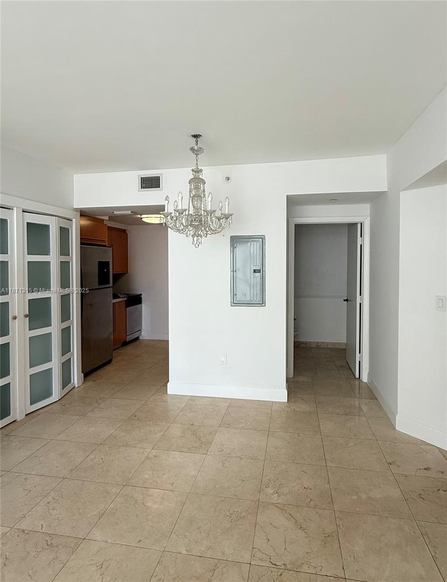 6365 Collins Avenue, Unit 904 Miami Beach, FL 33141 - Photo 16 of 35 a view of a livingroom with a chandelier