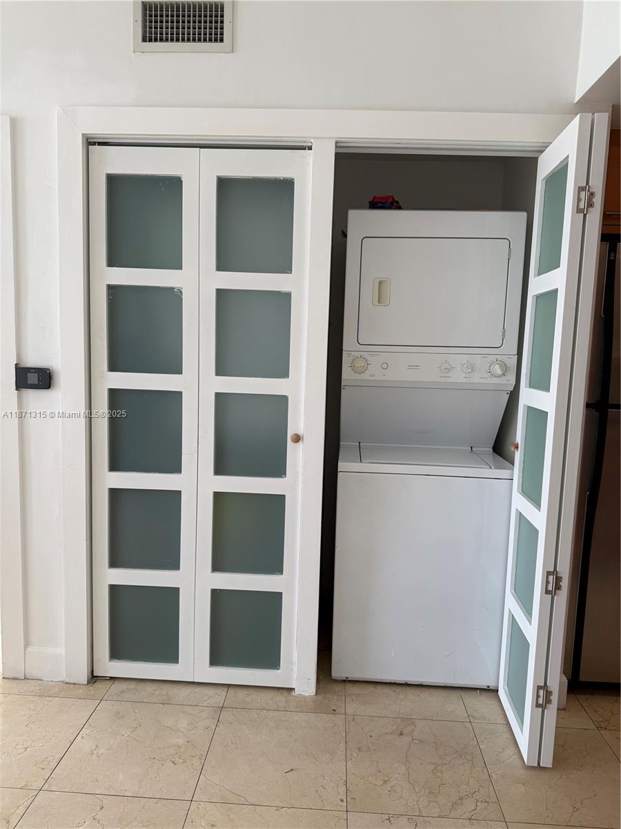 6365 Collins Avenue, Unit 904 Miami Beach, FL 33141 - Photo 21 of 35 a utility room with washer and dryer