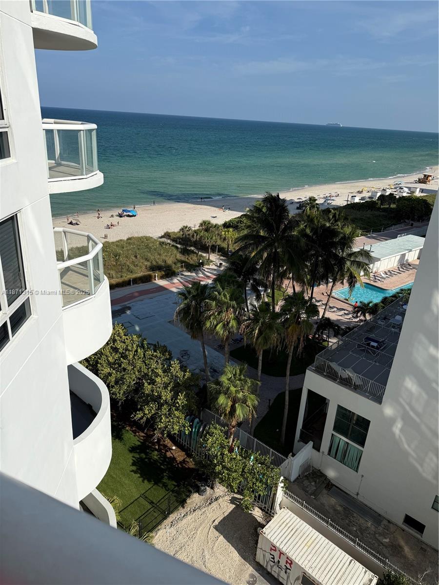 6365 Collins Avenue, Unit 904 Miami Beach, FL 33141 - Photo 29 of 35 a view of a terrace with wooden floor and a ocean view