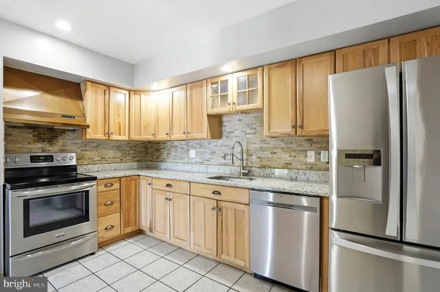 a view of an empty room with glass door and windows