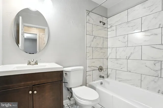 a bedroom with a large bed and a potted plant