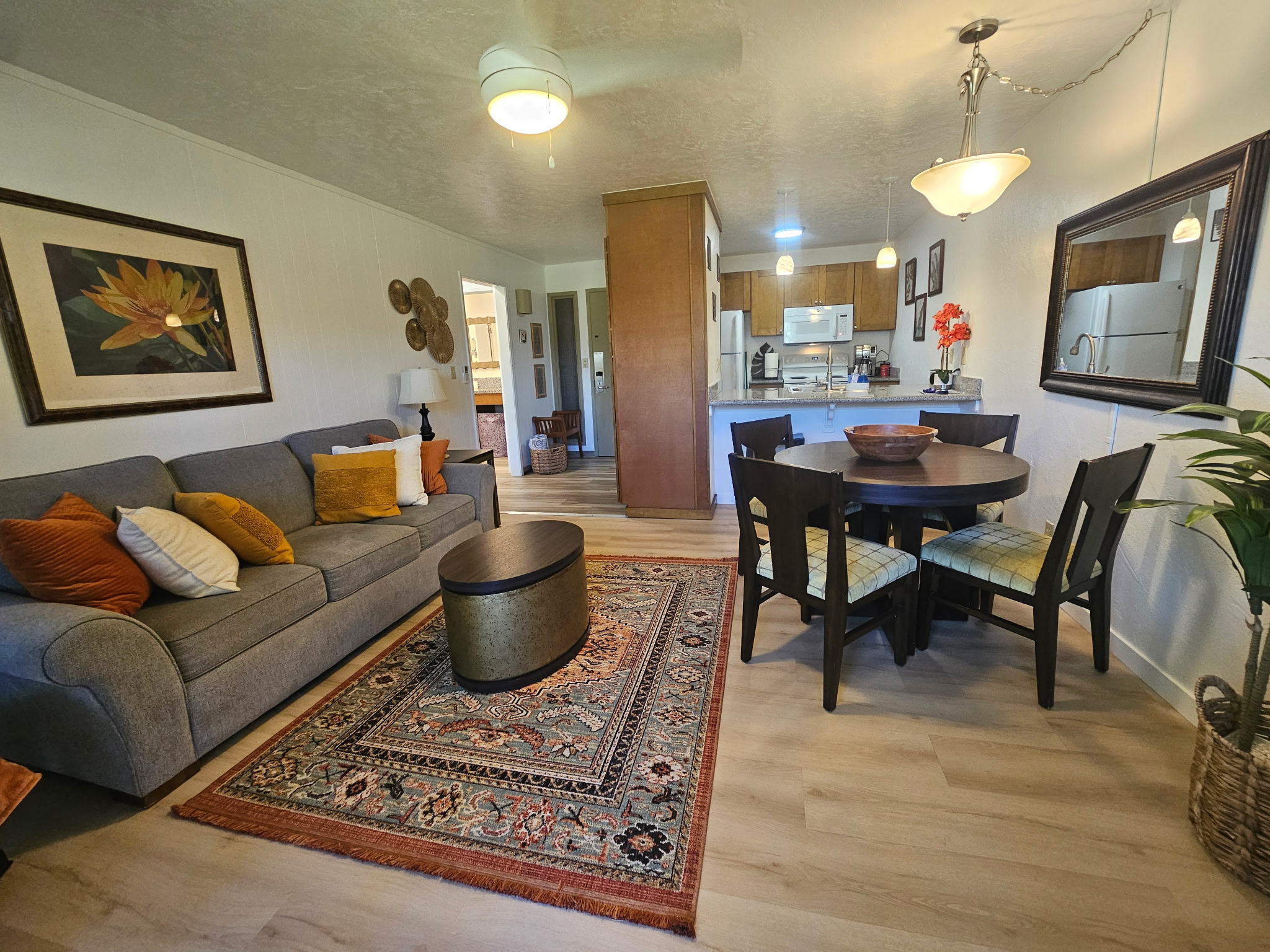 a living room with furniture a flat screen tv and a table