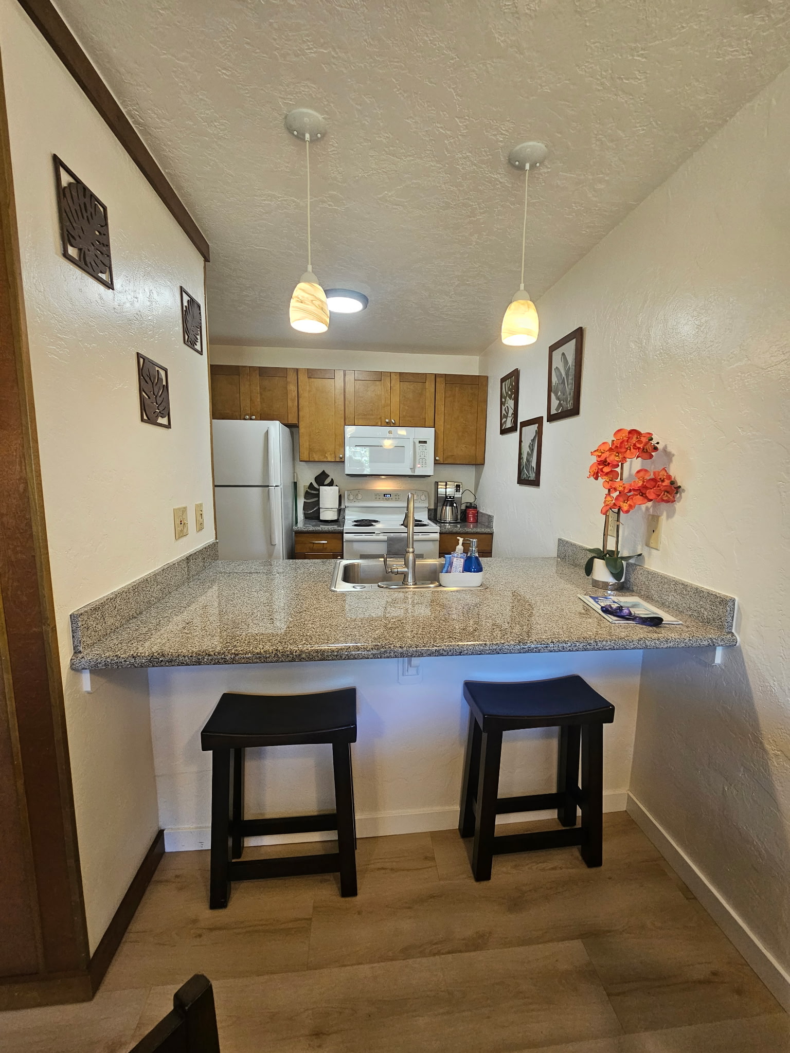 525 Aleka Loop, Unit D3 Kapaa, HI 96746 - Photo 9 of 13 a room with granite countertop furniture and a fireplace