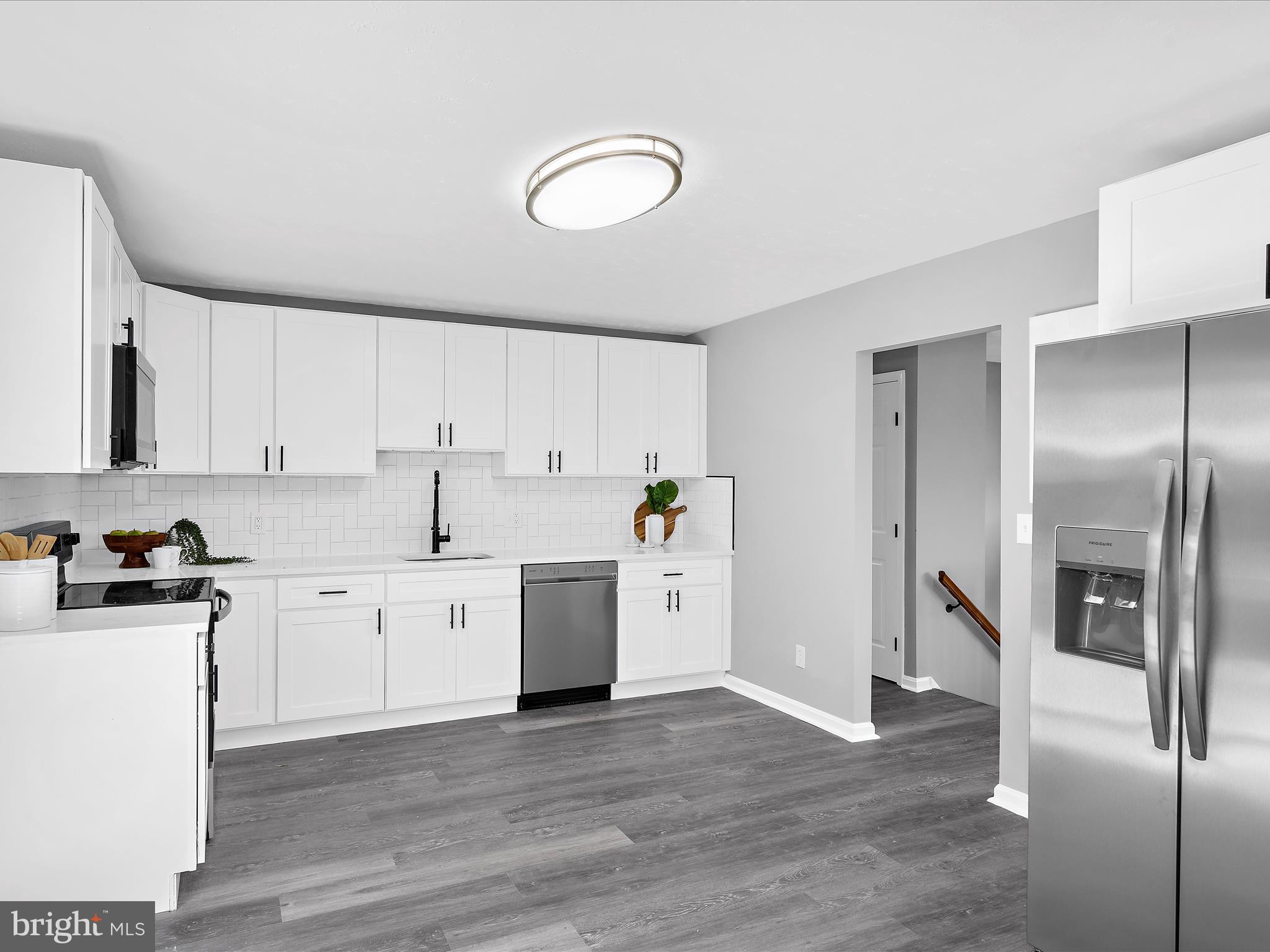 74 Ayers Drive Rising Sun, MD 21911 - Photo 12 of 41 a kitchen with granite countertop a stove top oven sink and cabinets