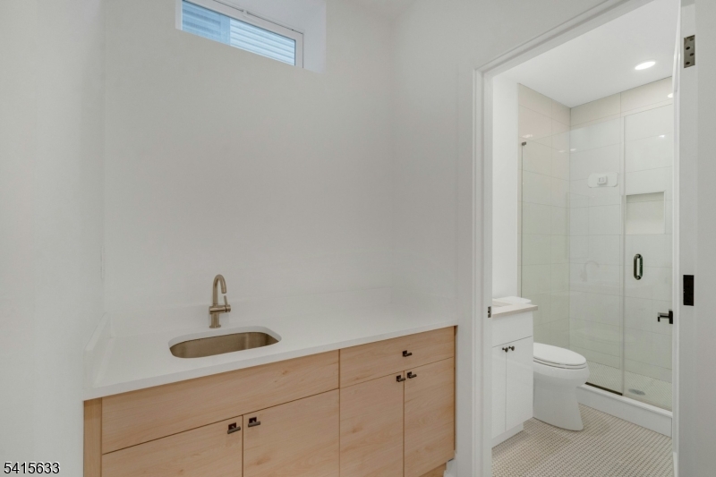71 Mission Street, Unit 2 Montclair, NJ 07042 - Photo 22 of 25 a bathroom with a toilet a sink and mirror
