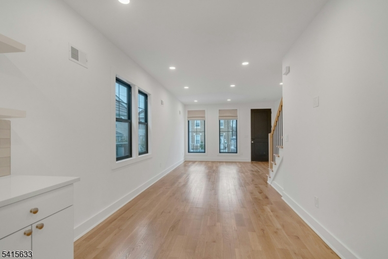 71 Mission Street, Unit 2 Montclair, NJ 07042 - Photo 6 of 25 a view of an empty room with wooden floor and a window