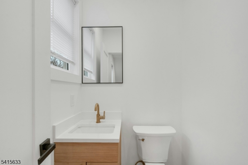 71 Mission Street, Unit 2 Montclair, NJ 07042 - Photo 7 of 25 a bathroom with a sink a toilet and mirror