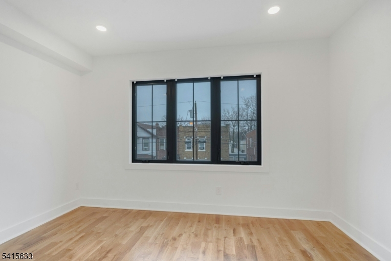71 Mission Street, Unit 2 Montclair, NJ 07042 - Photo 10 of 25 an empty room with wooden floor and windows