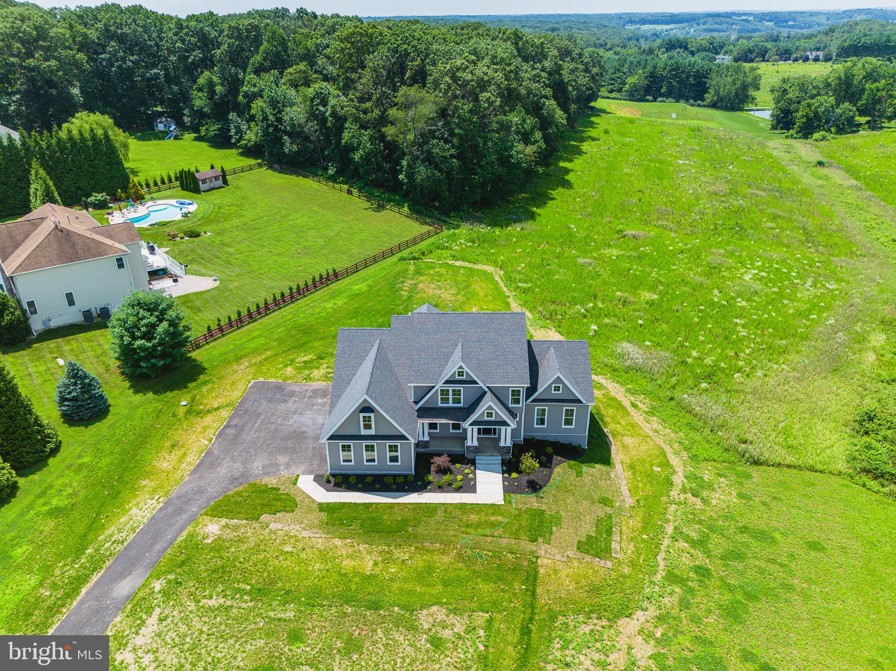 an aerial view of a house with a garden and trees