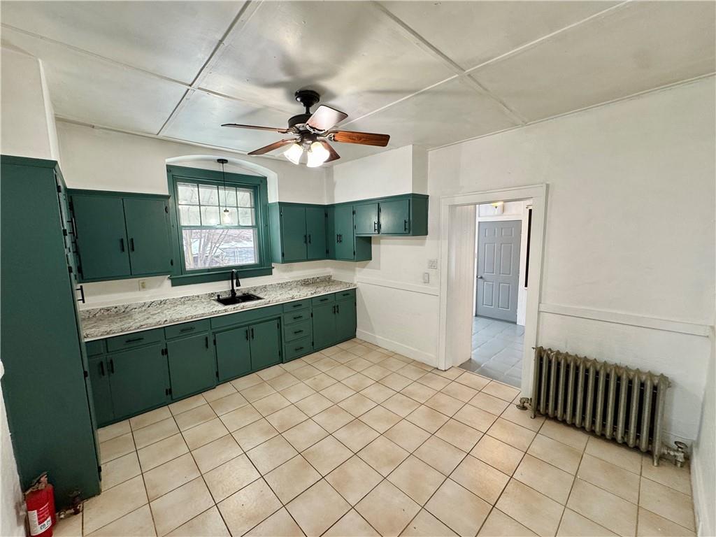 218 Clifford Avenue Apollo, PA 15613 - Photo 11 of 32 a large white kitchen with a sink a window and stainless steel appliances