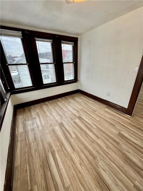 218 Clifford Avenue Apollo, PA 15613 - Photo 22 of 32 an empty room with wooden floor and windows