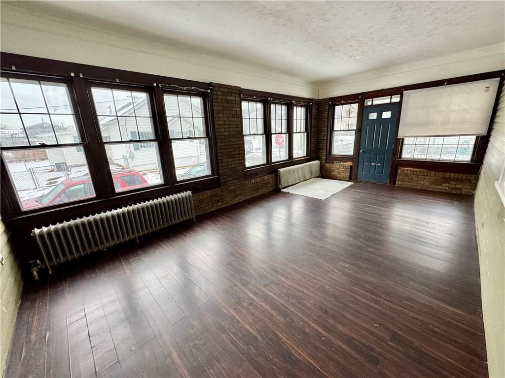 218 Clifford Avenue Apollo, PA 15613 - Photo 3 of 32 wooden floor in an empty room with a window