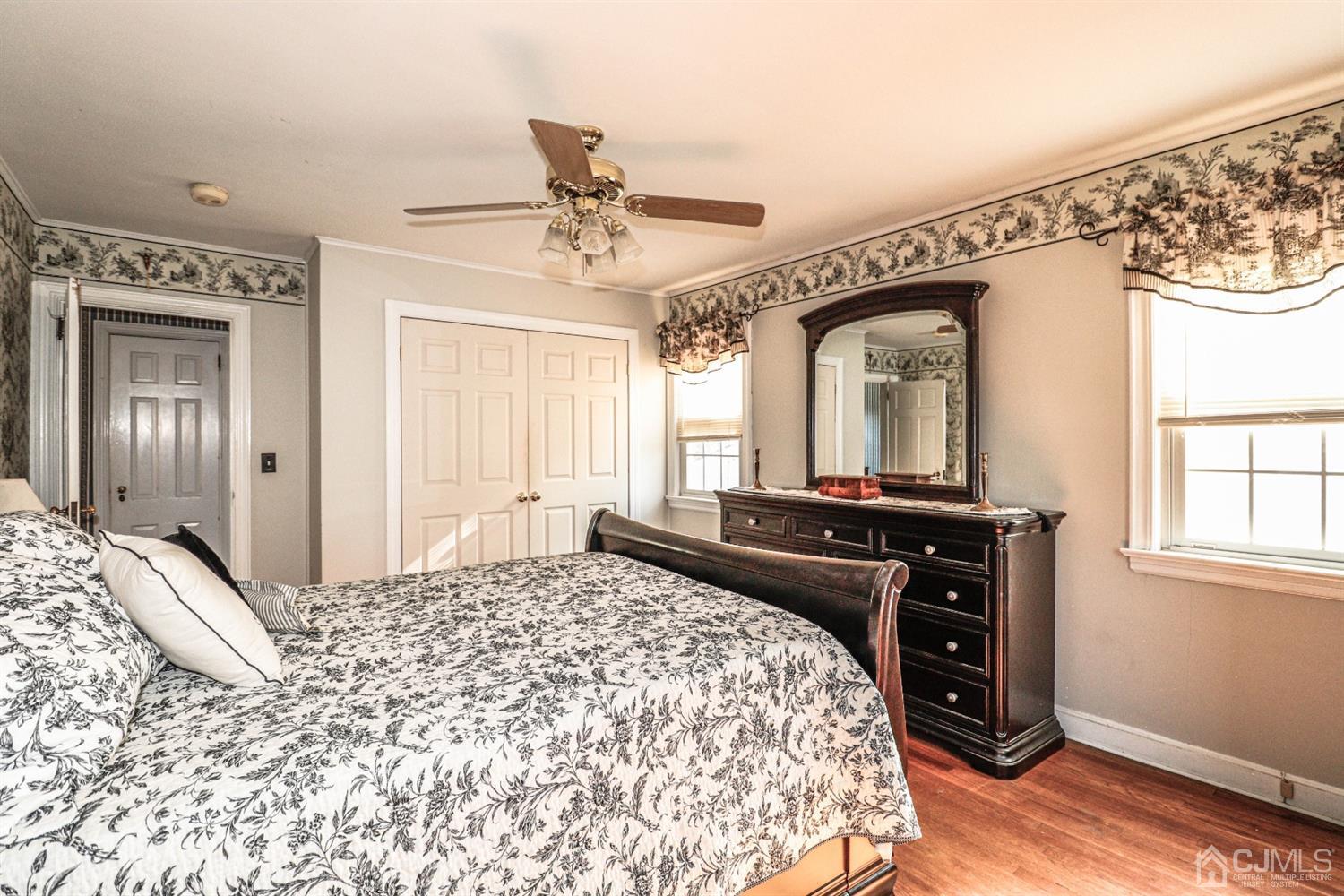 485 Whitewood Road Union, NJ 07083 - Photo 17 of 24 a bedroom with a bed and a mirror on a dresser