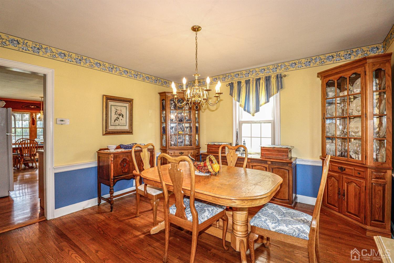 485 Whitewood Road Union, NJ 07083 - Photo 5 of 24 a dining room with furniture a chandelier and wooden floor