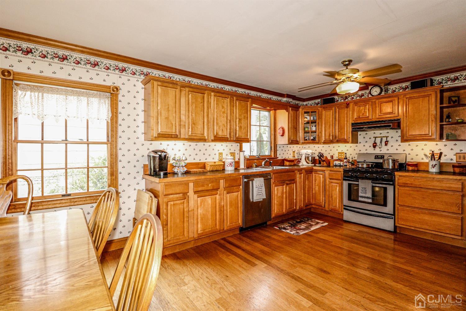 485 Whitewood Road Union, NJ 07083 - Photo 7 of 24 a kitchen with stainless steel appliances granite countertop a stove a sink dishwasher and a refrigerator with wooden floor