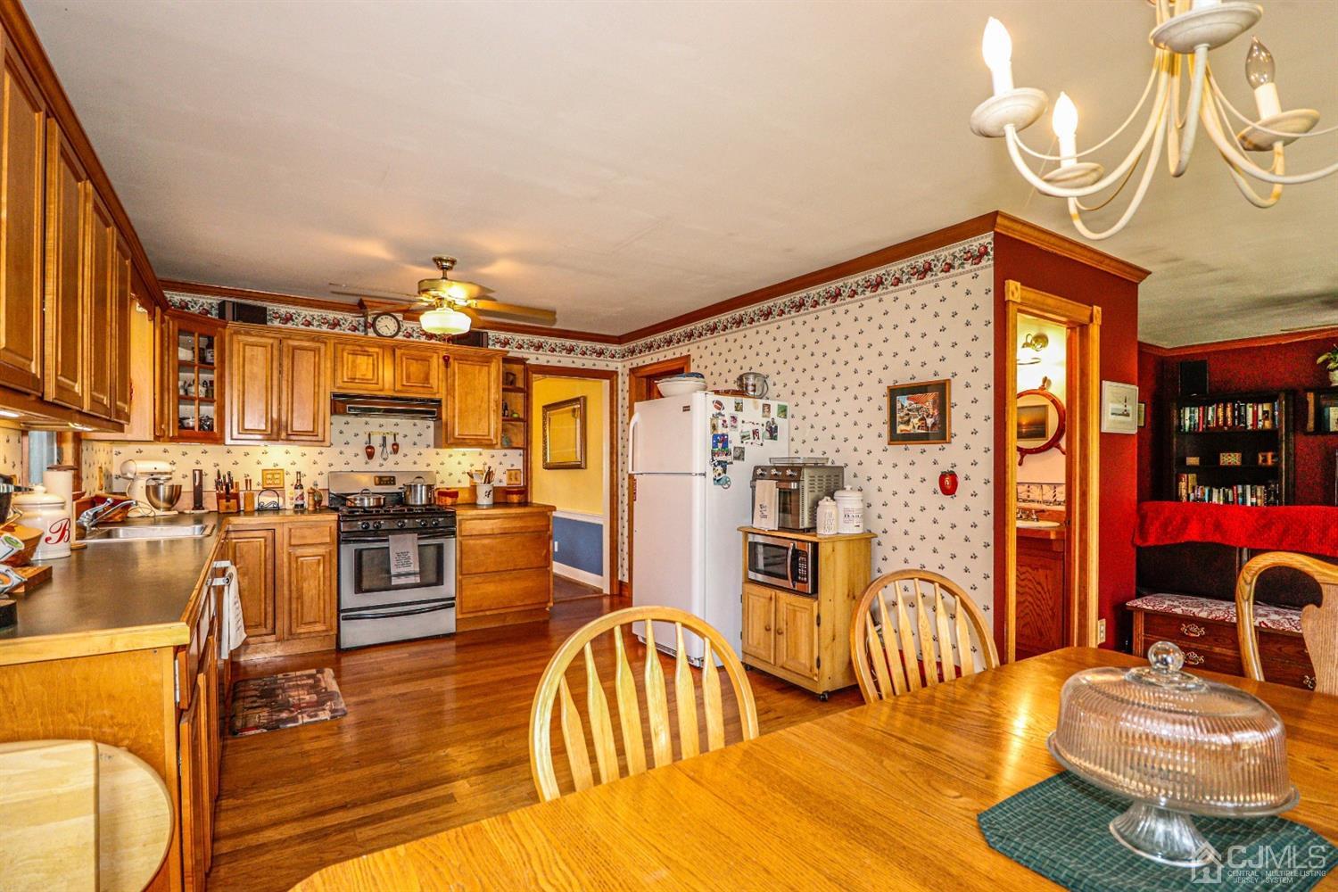 485 Whitewood Road Union, NJ 07083 - Photo 9 of 24 a living room with furniture a flat screen tv and kitchen view