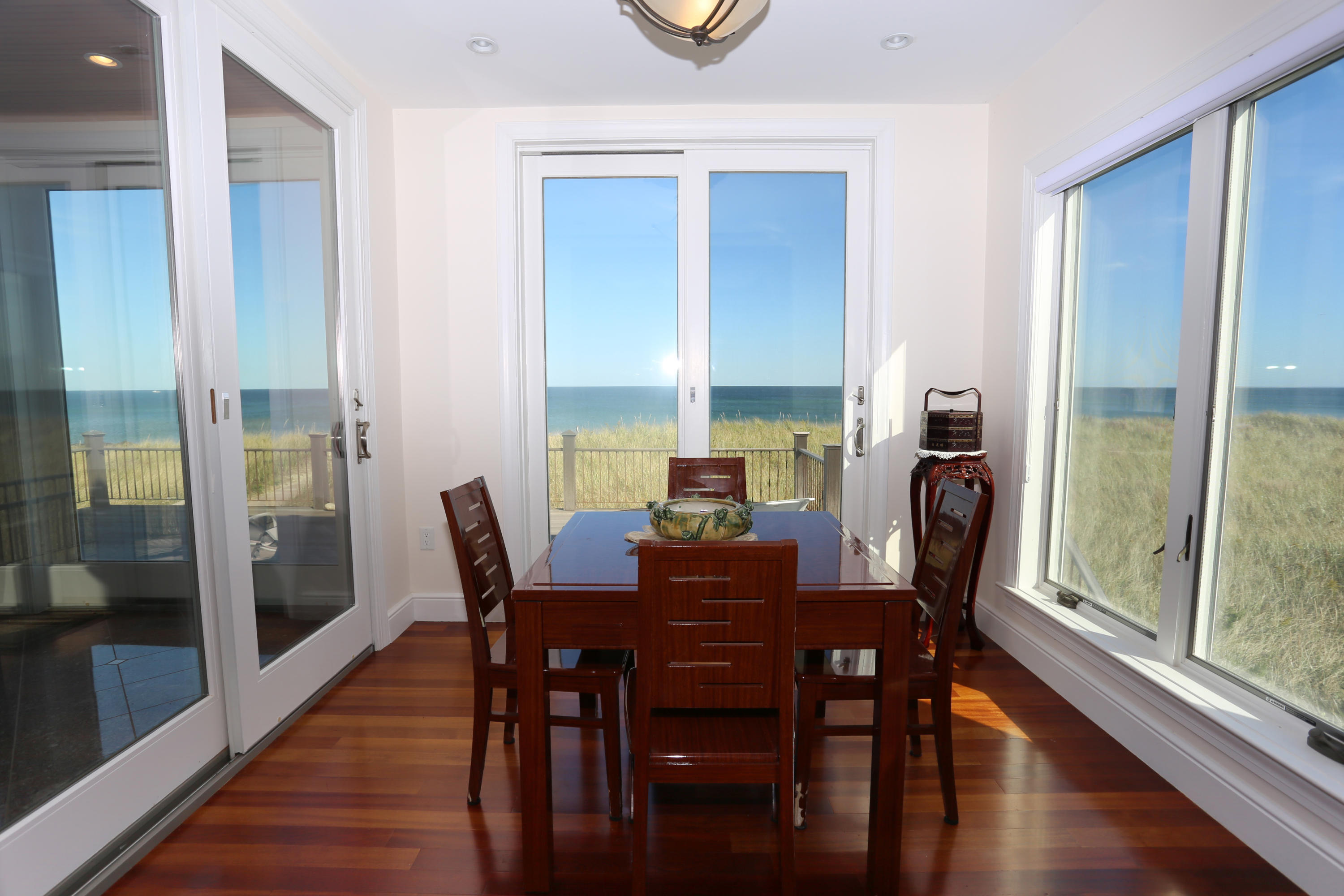99 Phillips Road Sagamore Beach, MA 02562 - Photo 13 of 30 a view of a dining room with furniture window and wooden floor