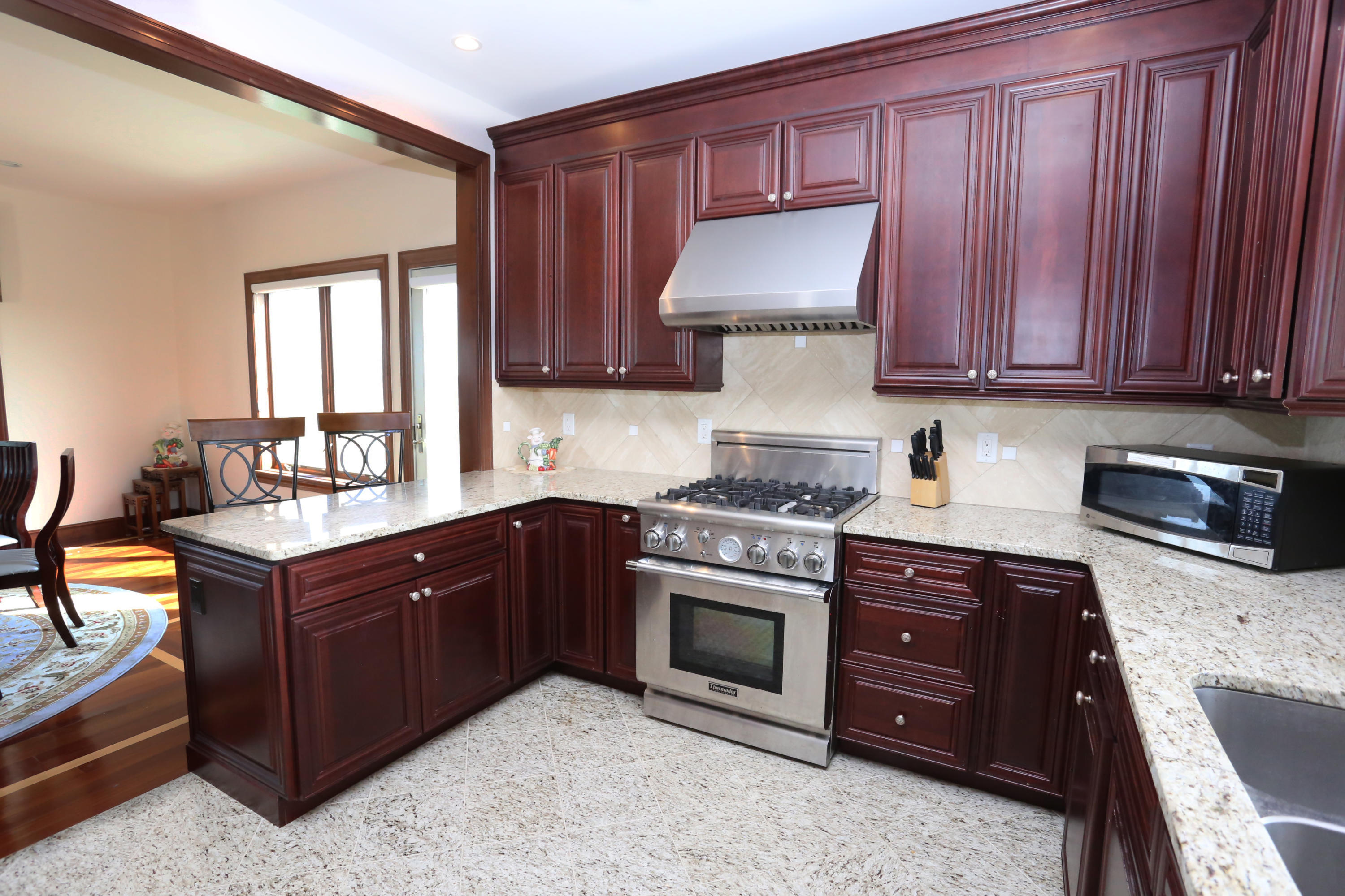99 Phillips Road Sagamore Beach, MA 02562 - Photo 17 of 30 a kitchen with stainless steel appliances granite countertop a stove a sink dishwasher and a refrigerator