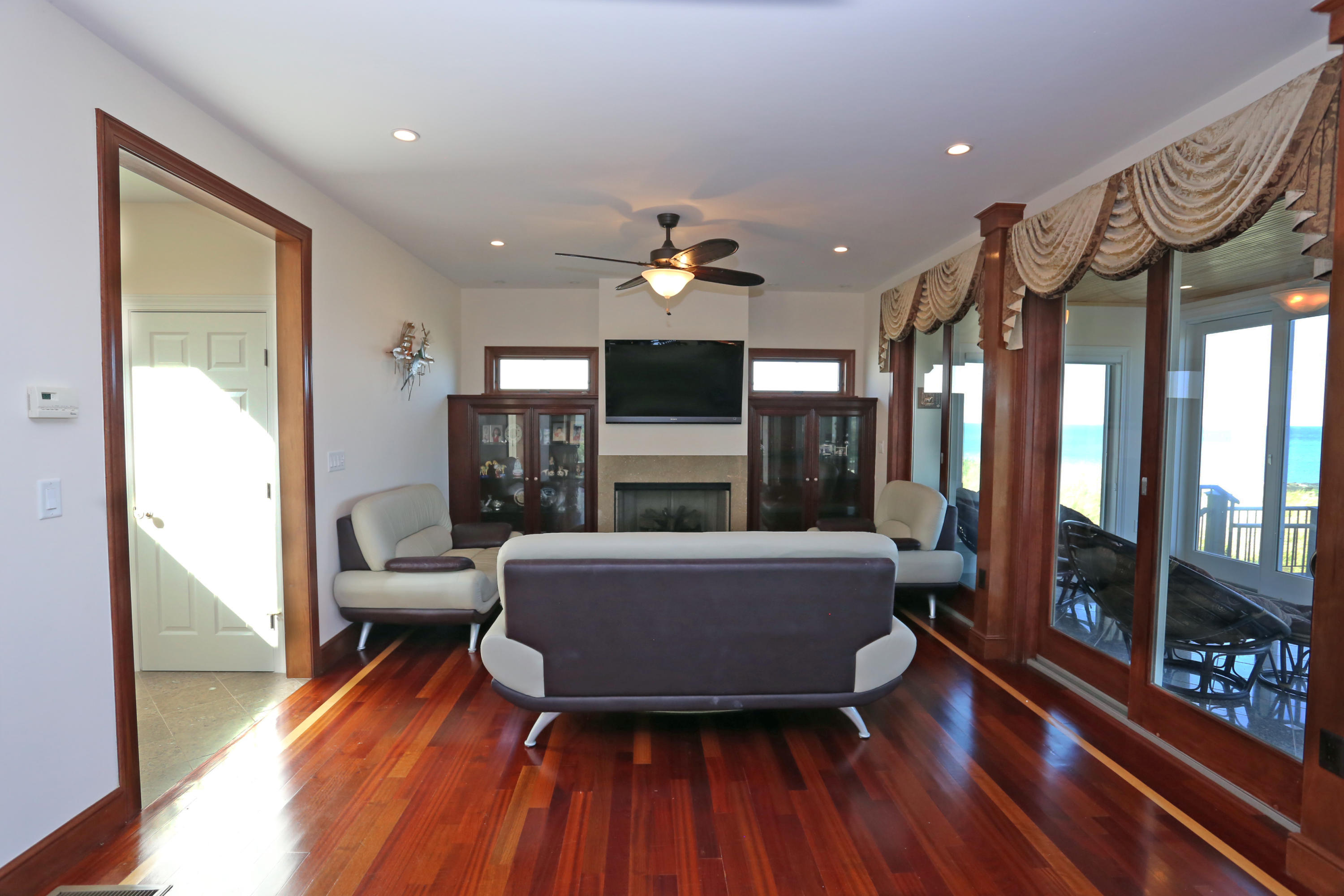 99 Phillips Road Sagamore Beach, MA 02562 - Photo 19 of 30 a living room with furniture and a fireplace