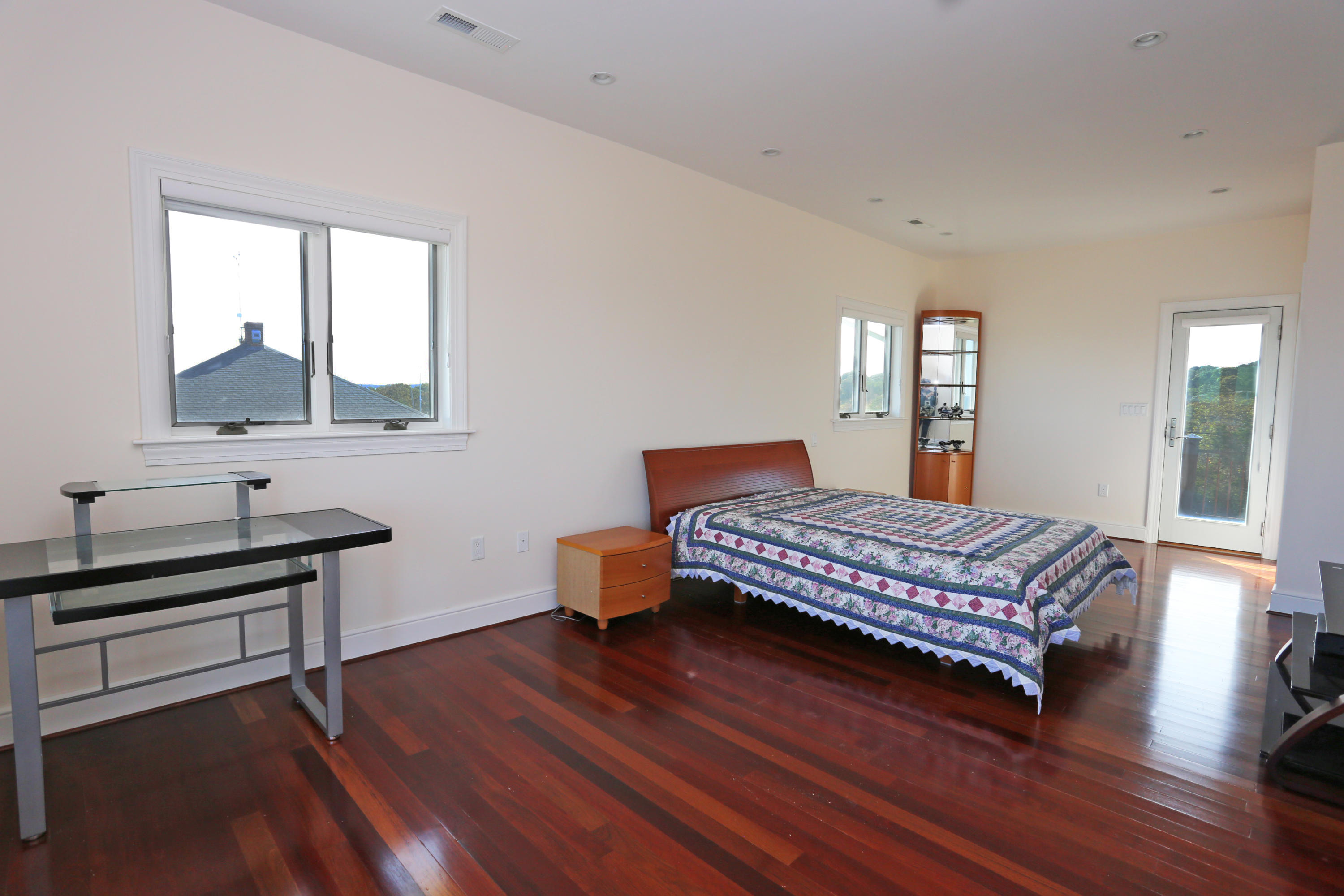 99 Phillips Road Sagamore Beach, MA 02562 - Photo 24 of 30 a bedroom with a bed and wooden floor