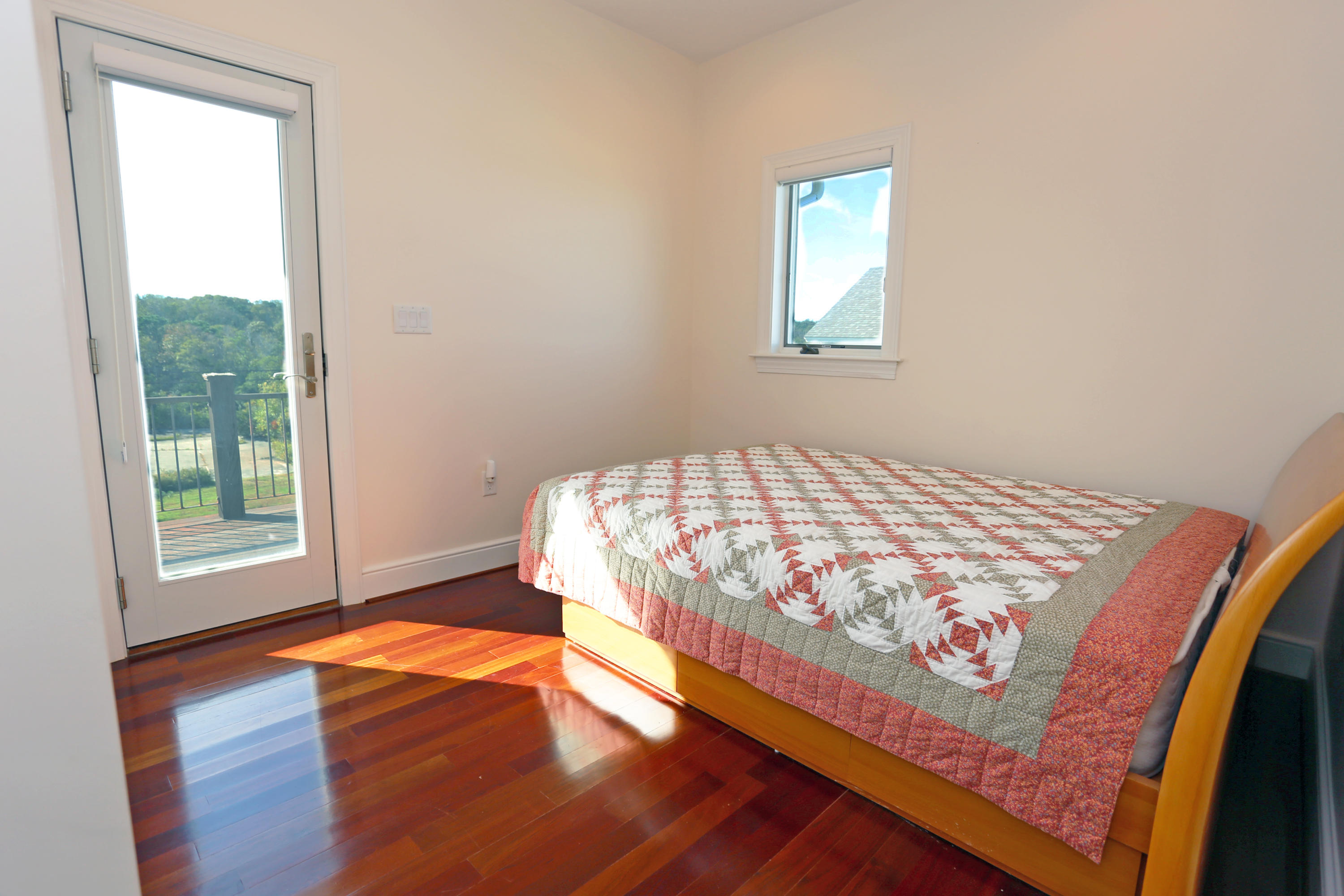 99 Phillips Road Sagamore Beach, MA 02562 - Photo 28 of 30 a bedroom with a bed and wooden floor