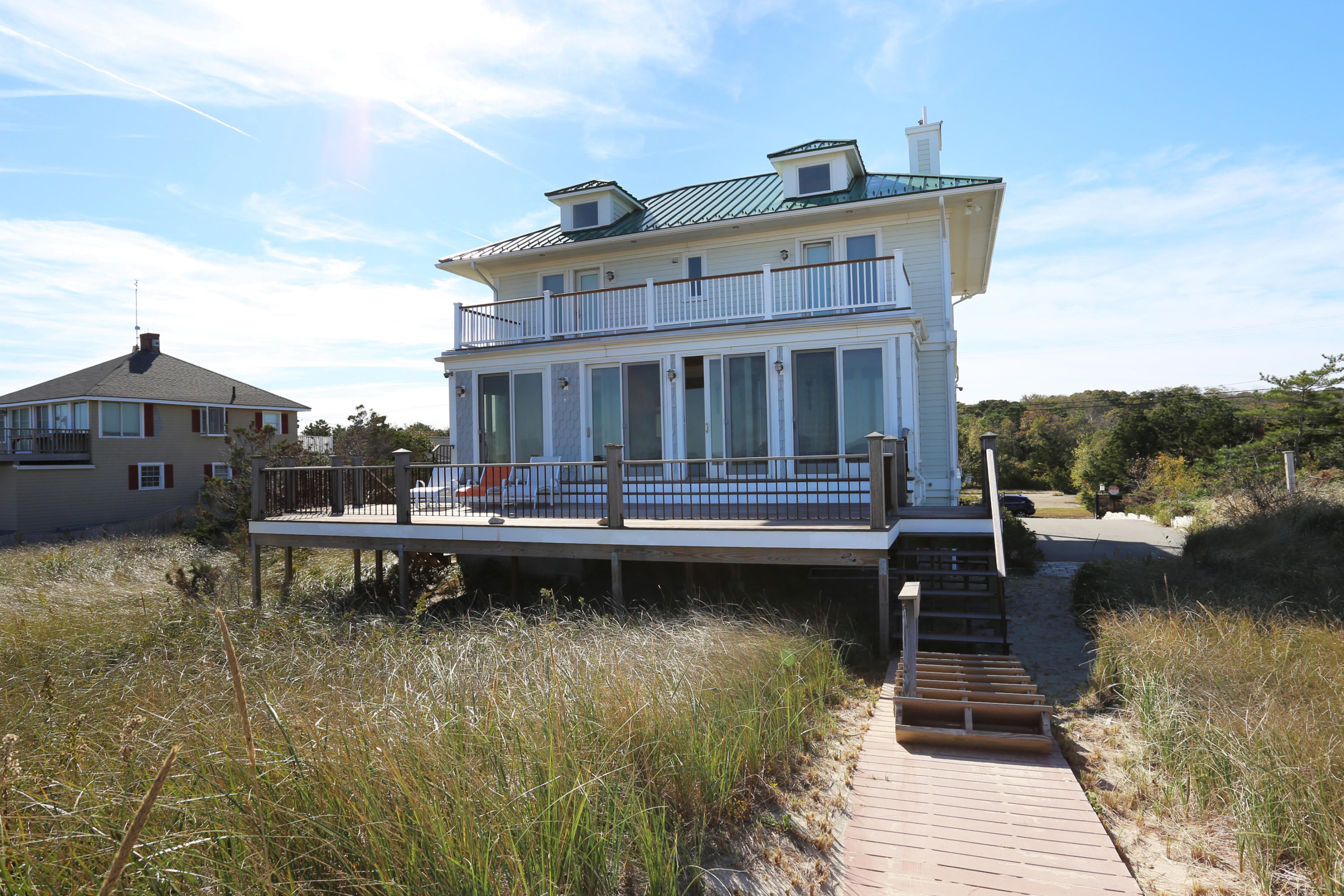 99 Phillips Road Sagamore Beach, MA 02562 - Photo 7 of 30 a view of a lake with a deck