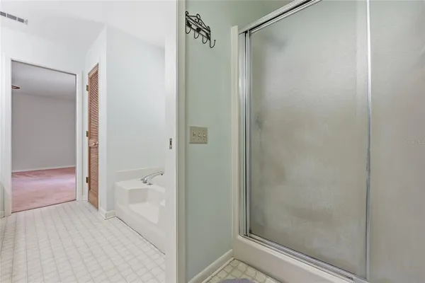 a bathroom with a shower and a bath tub