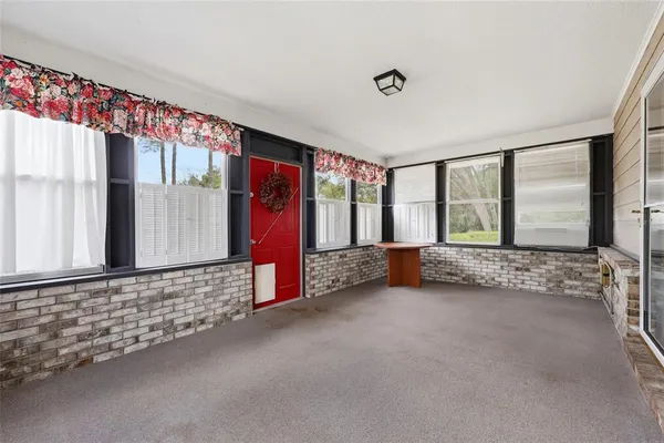 a view of an empty room with large windows