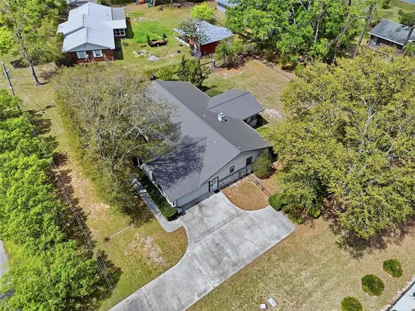 an aerial view of a house with a yard