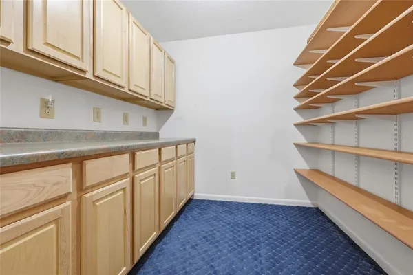 a view of a closet with racks on the wall
