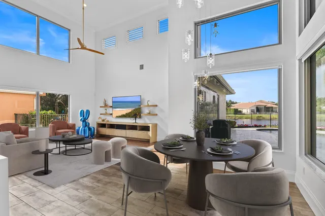 a spacious bedroom with a large bed and a chandelier