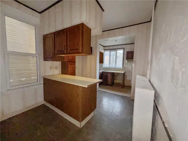 a view of kitchen with furniture and wooden floor