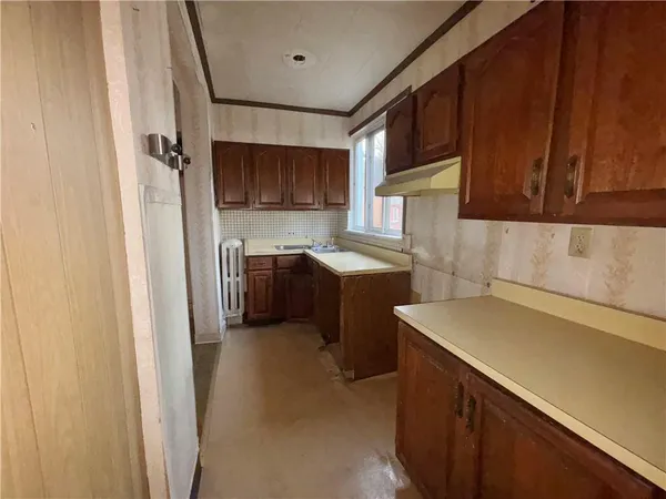 a kitchen with a sink a stove and refrigerator