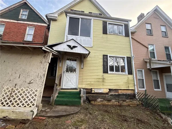 a front view of a house with a yard