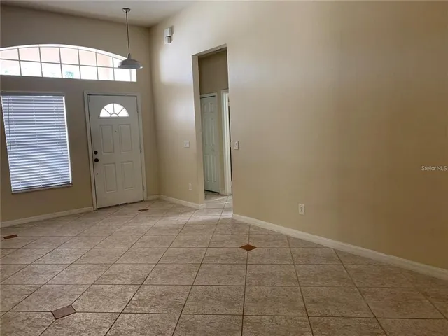 an empty room with windows and entrance