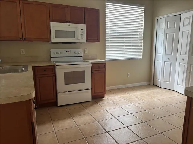 a kitchen with a stove and a microwave