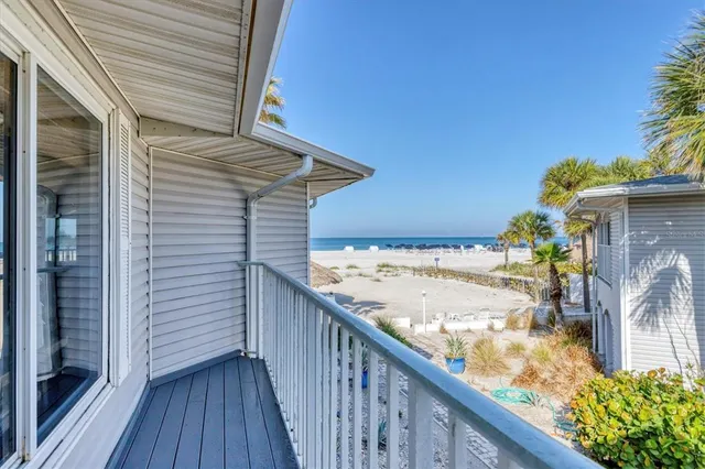 a living room with furniture and a baby crib