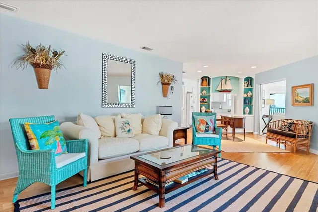 a living room with furniture and a wooden floor