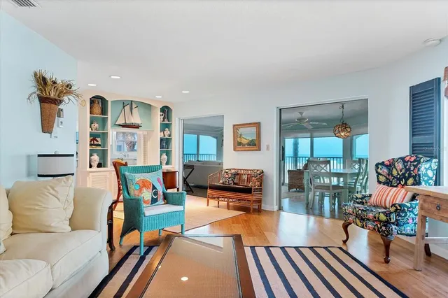 a living room with furniture and a floor to ceiling window