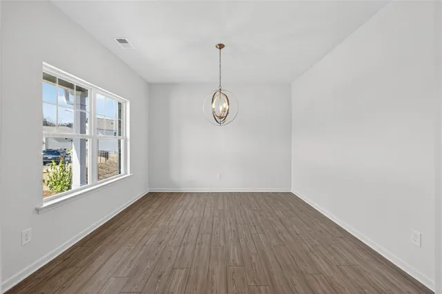 a view of an room with wooden floor and window