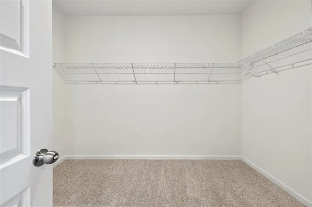 an empty room with closet and mirrors