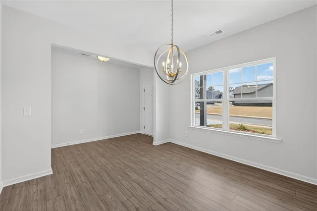 a view of a room with wooden floor and window